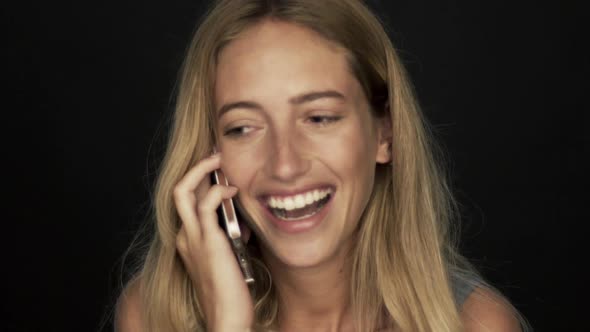 Young woman talking on cell phone and laughing