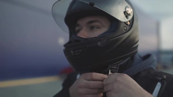 Young Attractive Motorcyclist with Black Helmet on Street