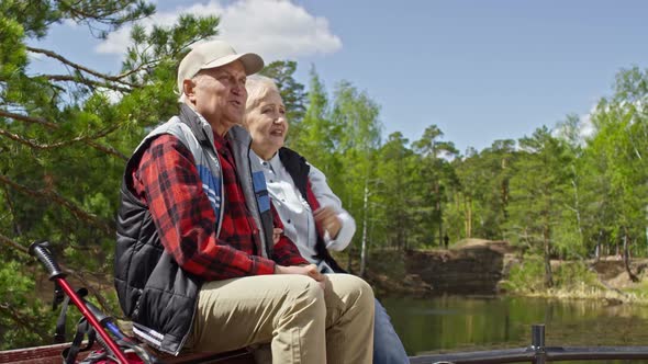 Elderly Couple Resting on Park Bench