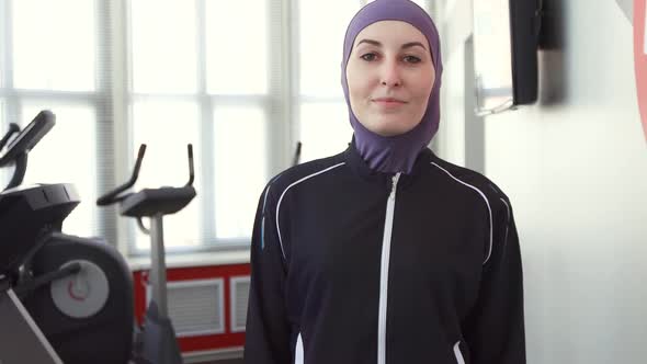 Portrait of a Sporty Woman in Hijab in the Gym