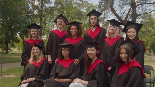 Group of Excited Diverse Multiethnic Graduates Celebrating Graduation Day