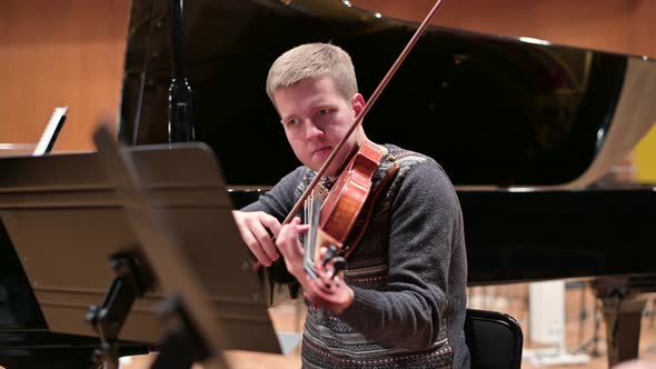 violinist playing the violin in the orchestra, rehearsal before the performance