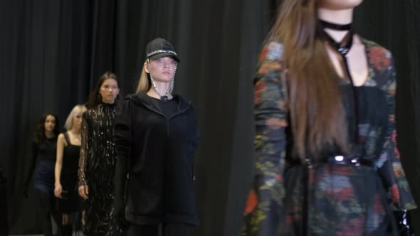 Several Female Models Walking in Row on Fashionable Luxury Vogue Show Runway