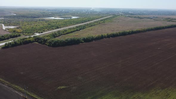 a Highway Stretching to the Horizon Among Agricultural Fields