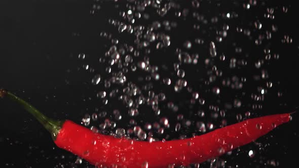 Super Slow Motion on Red Chilli Pepper Droplets of Water