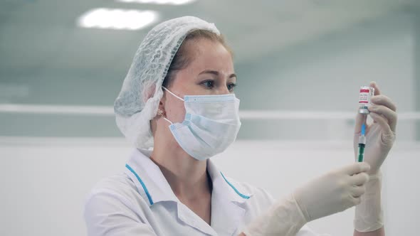 Syringe is Getting Filled with Medicine By a Female Doctor