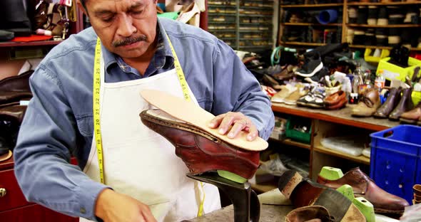 Cobbler working on shoe sole