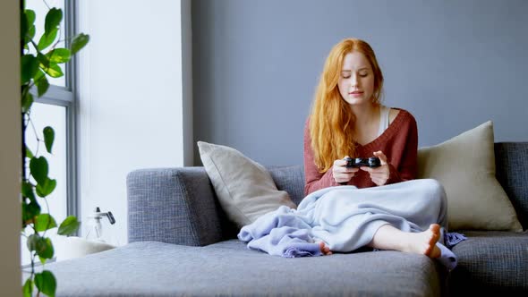 Woman playing video games in living room 4k