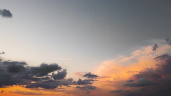 A Panorama of a Dark Evening Sky with Grayorange Clouds in Sunlight