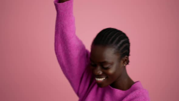 Smiling woman volunteer waving at the camera and pointing at the phone