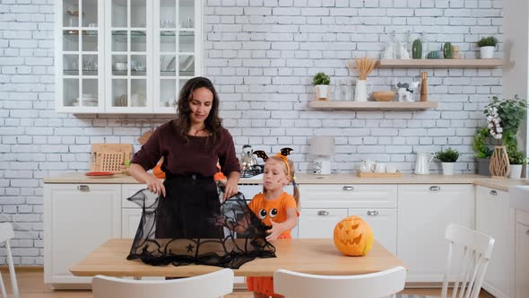 Mother with Daughter Decorate Table for Halloween