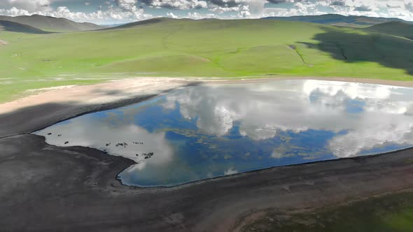 Lake in The Middle of The Treeless Meadow with Aerial View