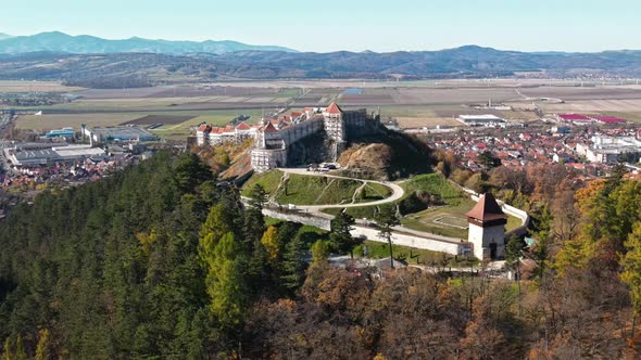 Aerial drone view of The Rasnov Fortress in Romania. Medieval fortress with tourists on the top of t