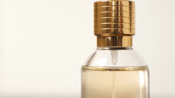 Parfume bottle details with golden cap close-up slow tilt 4K 3840X2160 UHD video - Tilting on fragra