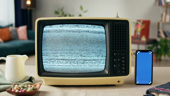 Old Television with Grey Blank Screen on Home Background Living Room Using Smartphone with Chroma