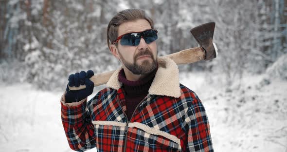 Portrait of Bearded Man Posing on Camera at Snowy Forest