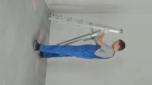 Repairman with Ladder Inspecting House