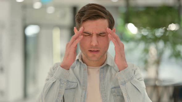 Portrait of Creative Young Man Having Headache