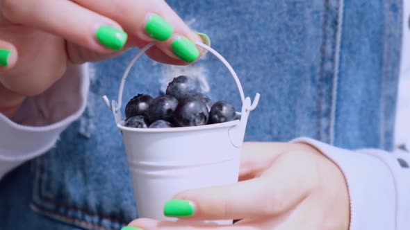 Woman Holding Bowl with Fresh Blueberries
