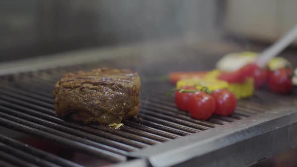 Chef Cooking Vegetable and Meet on the Grill in the Restaurant Kitchen