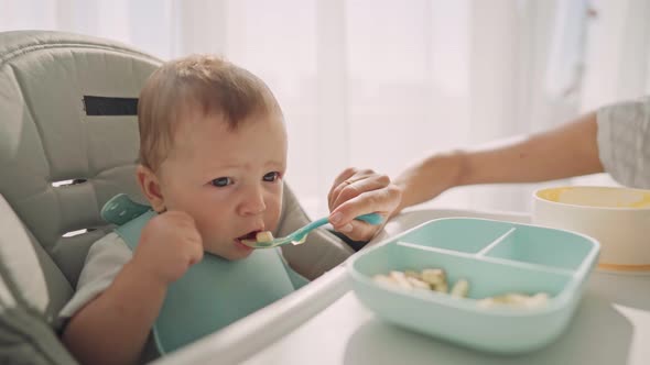 Parents Feed the Child with Banana Slices