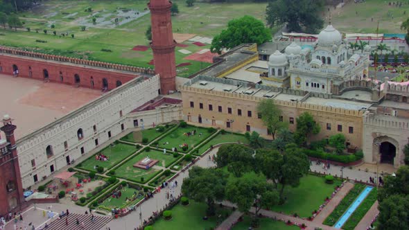 Drone flight to the Sikhism Temple (Gurdwara) passing over a Mosque, Children and ladies waving at t