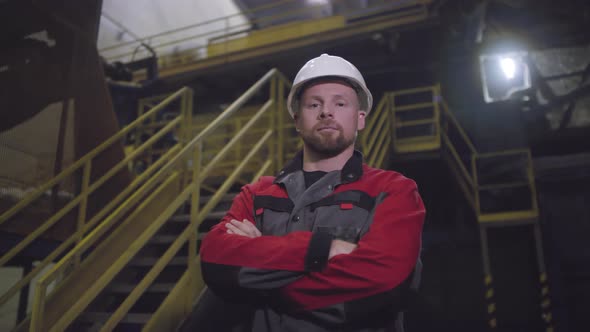 Caucasian Male Technician Posing at Industrial Plant