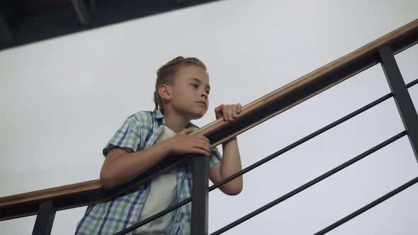 Curious Schoolboy Standing Stairway Alone