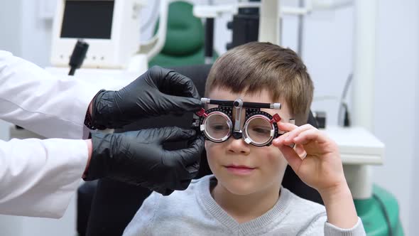 The Ophthalmologist Selects Lenses for the Boy By Means of a Trial Frame for Selection of Lenses