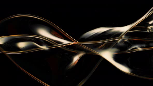 Super Slow Motion Shot of Swirling and Splashing Golden Oil Isolated on Black Background at 1000Fps