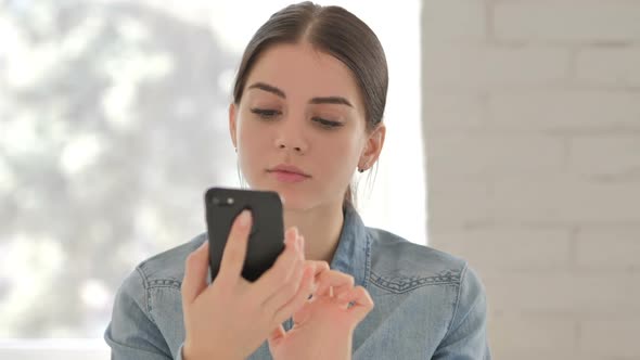 Portrait of Young Girl Busy Using Smartphone