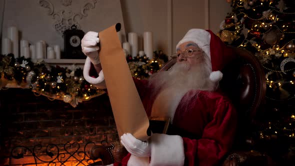 Santa Claus Reading Letter with List Gifts From Children for Christmas Holidays