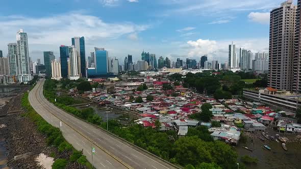 Aerial drone footage of Panama City contrast between poor area and rich buildings