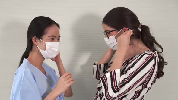 Doctor Wearing Face Mask Proficiently Talks with Patient at Hospital Ward