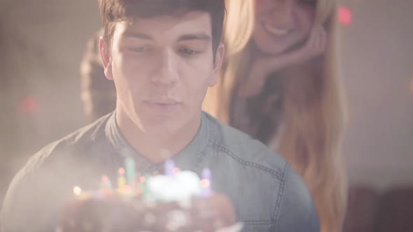 Portrait Handsome Guy Blowing the Candles on the Cake