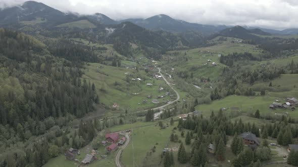 Ukraine, Carpathian Mountains: Village in the Mountains. Aerial, Flat, Gray