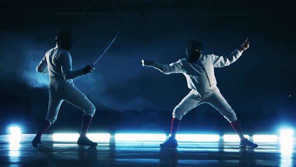 Fencing Match of Two Sportsmen Shown in Slow Motion