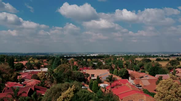 Colourfull, town reveal, dronefootage, trees, rooftops, highway, arial view, neighborhood