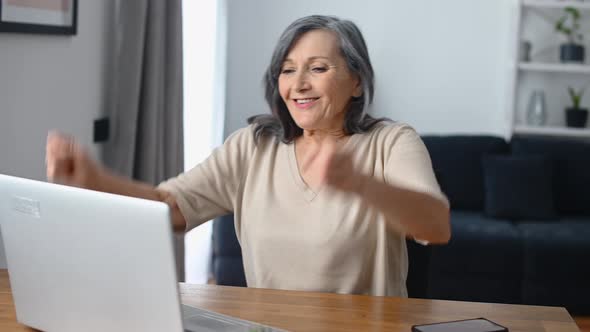 Middleaged Woman Using Laptop