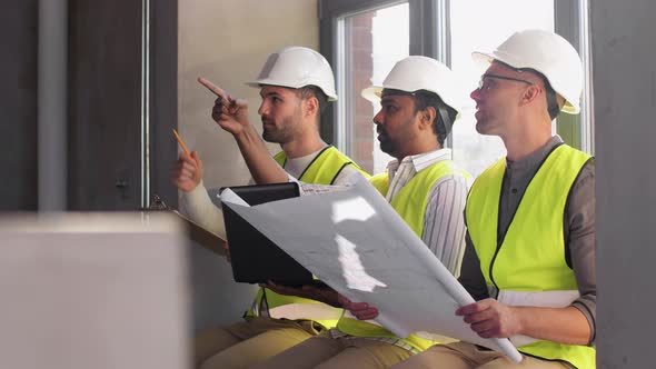 Male Architects in Helmets with Laptop at Office