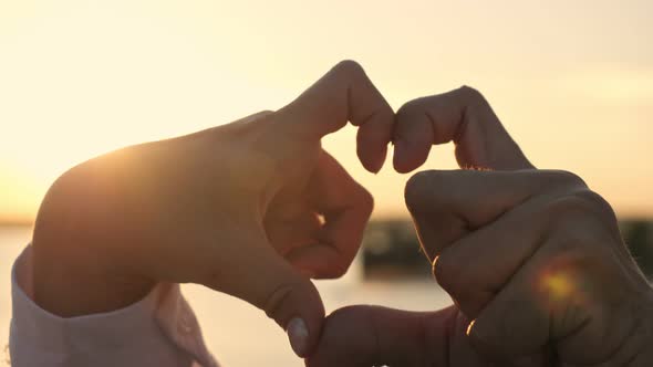 Disabled Couple Makes Heart with Hands at Sunlight Closeup
