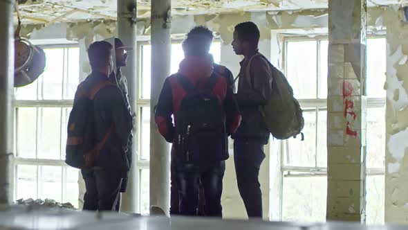 Group of Men Talking in Abandoned Building