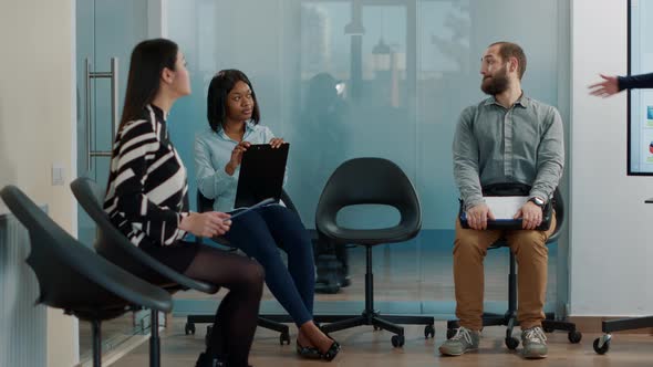 Pregnant Worker Asking African American Woman to Join Recruitment Meeting