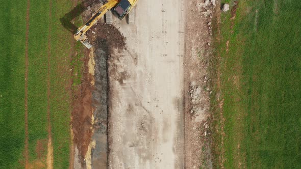 Aerial View of Yellow Bulldozer Collects Soil in the Field