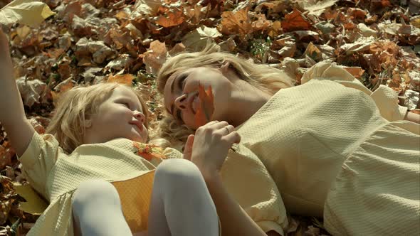 Mother and Daughter in Autumn Yellow Park.