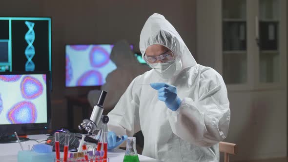 Doctor In Protective Suit Is Doing A Science Experiments And Developing Vaccine In A Modern Lab