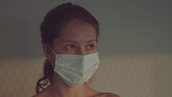 Portrait of a Young Woman Wearing Protective Medical Face Mask