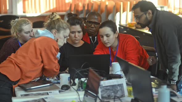 Multiracial Group of Students Are Talking and Working with Laptop at Desk at University Irrl.