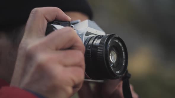 Hiker Looking Through Vintage Slr Camera