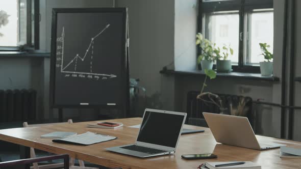 Business Graph Drawing on Chalkboard in Coworking Room